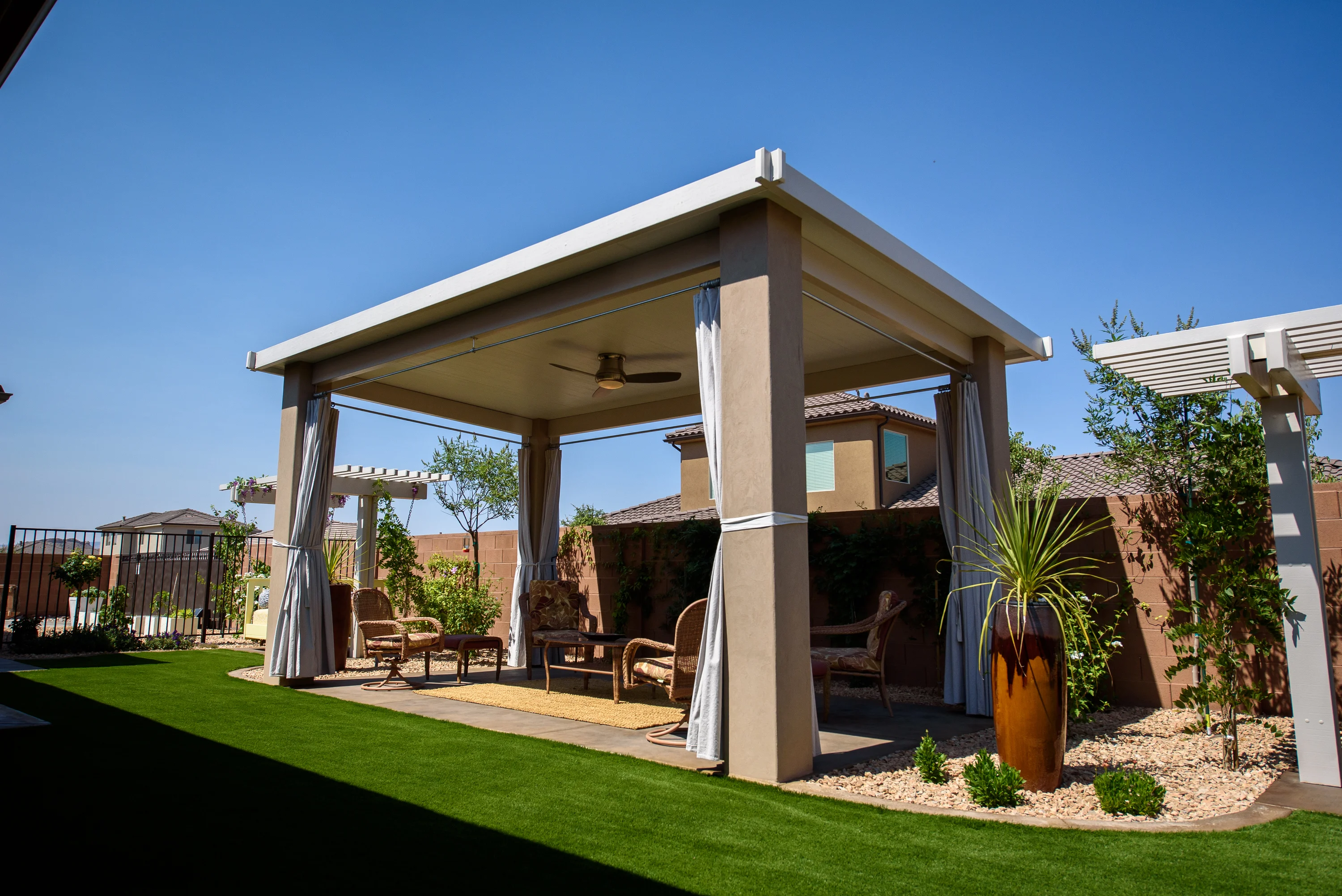 Modern standalone insulated cabana with drapes and ceiling fan