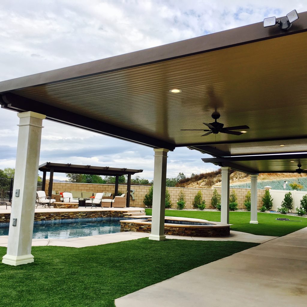 A finished aluminum patio cover over a poolside patio