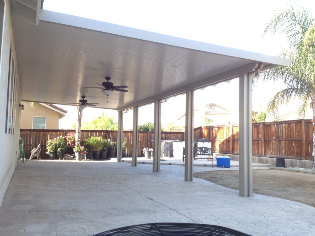 A completed aluminum patio cover installation over a Southern California backyard