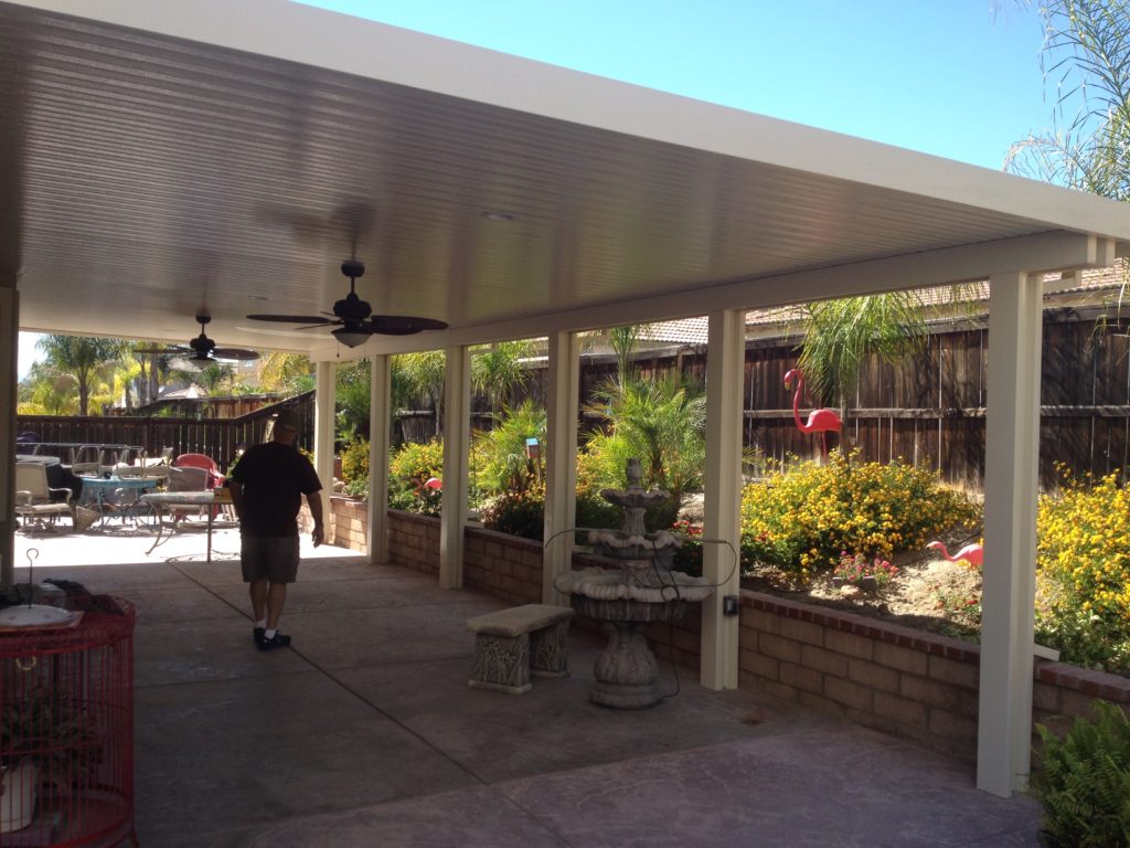 White Newport Solid cover over a patio with a fountain and garden