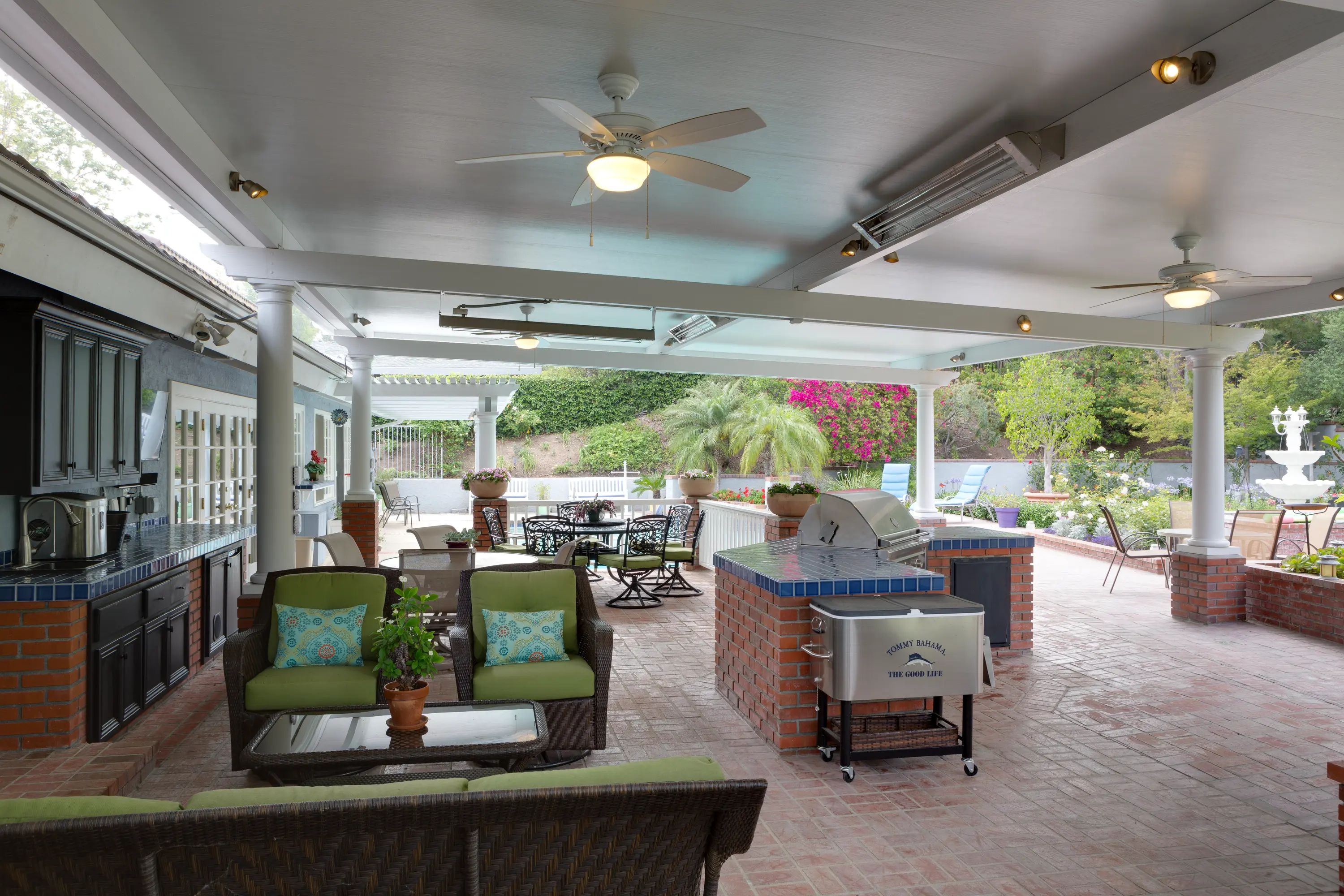 Large insulated outdoor room with multiple ceiling fans and heaters