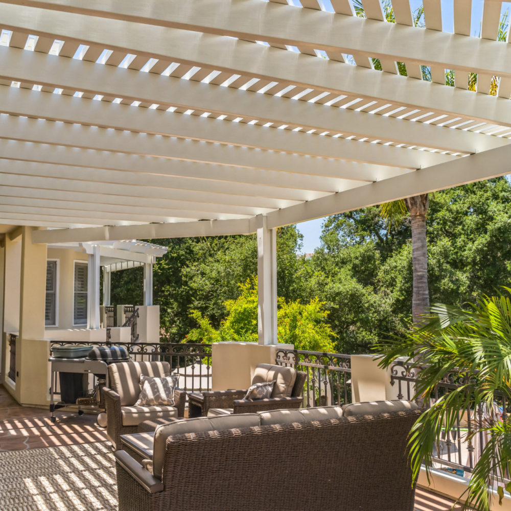 White curved-fan lattice patio cover over a furnished patio