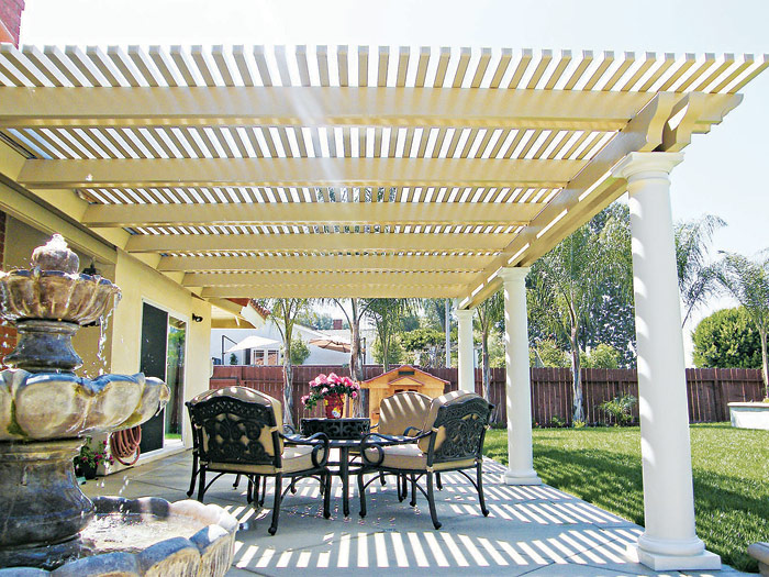 Cream lattice cover shading a garden dining area