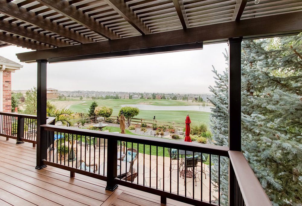 Lattice-shaded patio overlooking a country club fairway