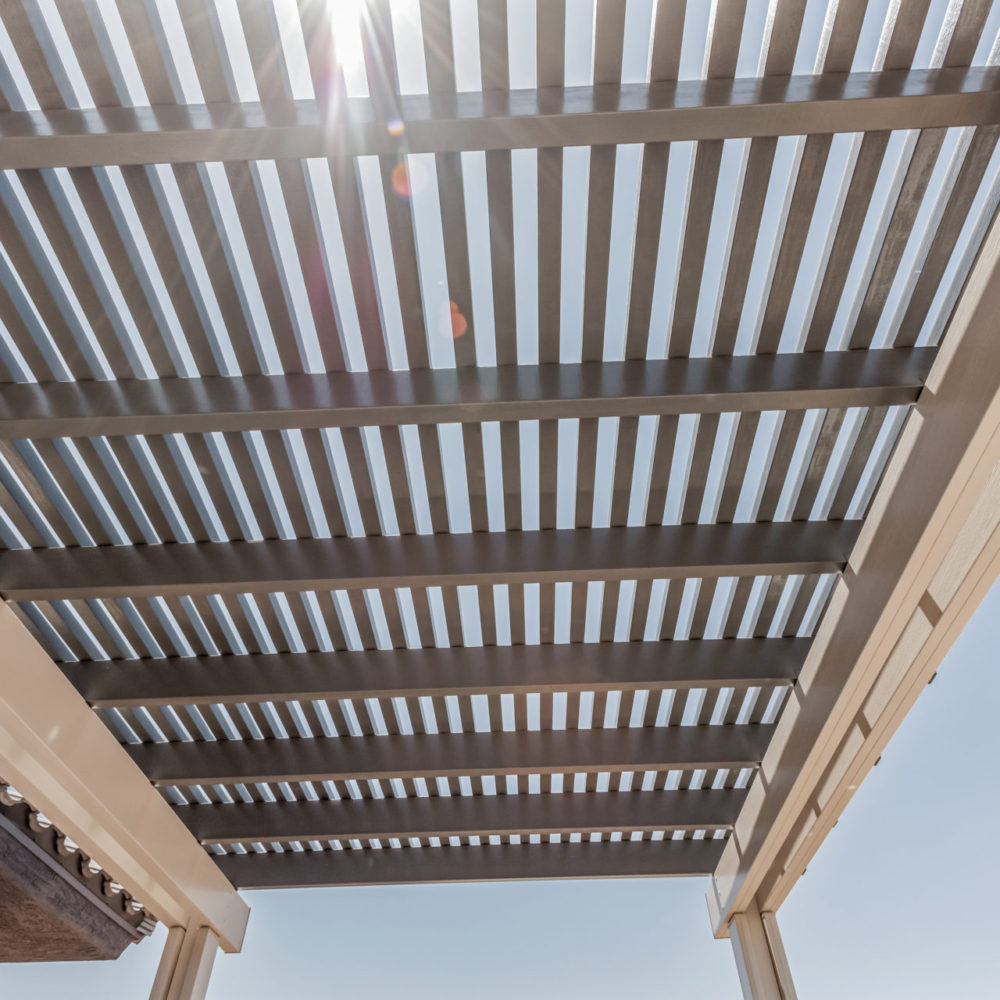 Lattice beam detail with sunlight flaring through the slats