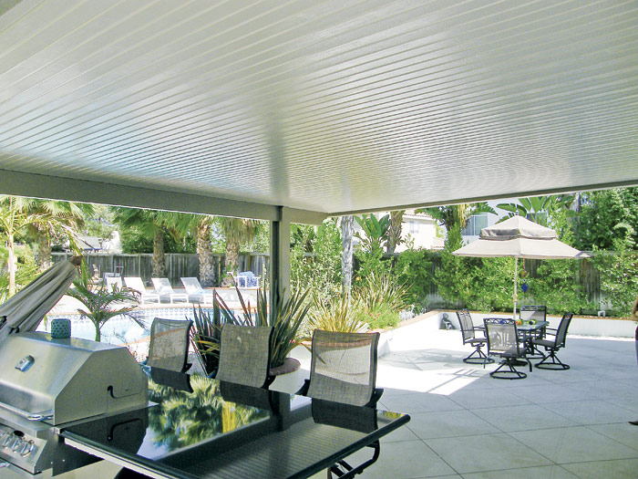 White solid cover over tropical poolside dining