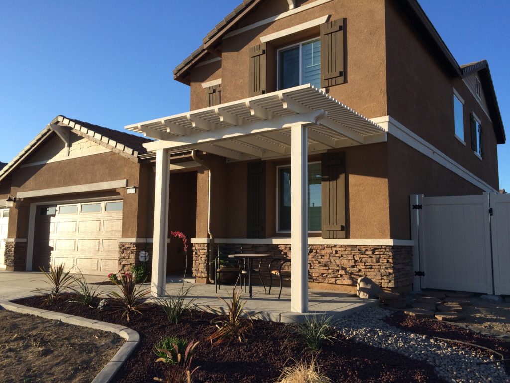 White Laguna Lattice cover over a front entry on a two-story home