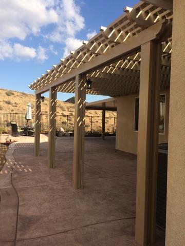 Laguna Lattice cover over a stamped-concrete patio with hillside views