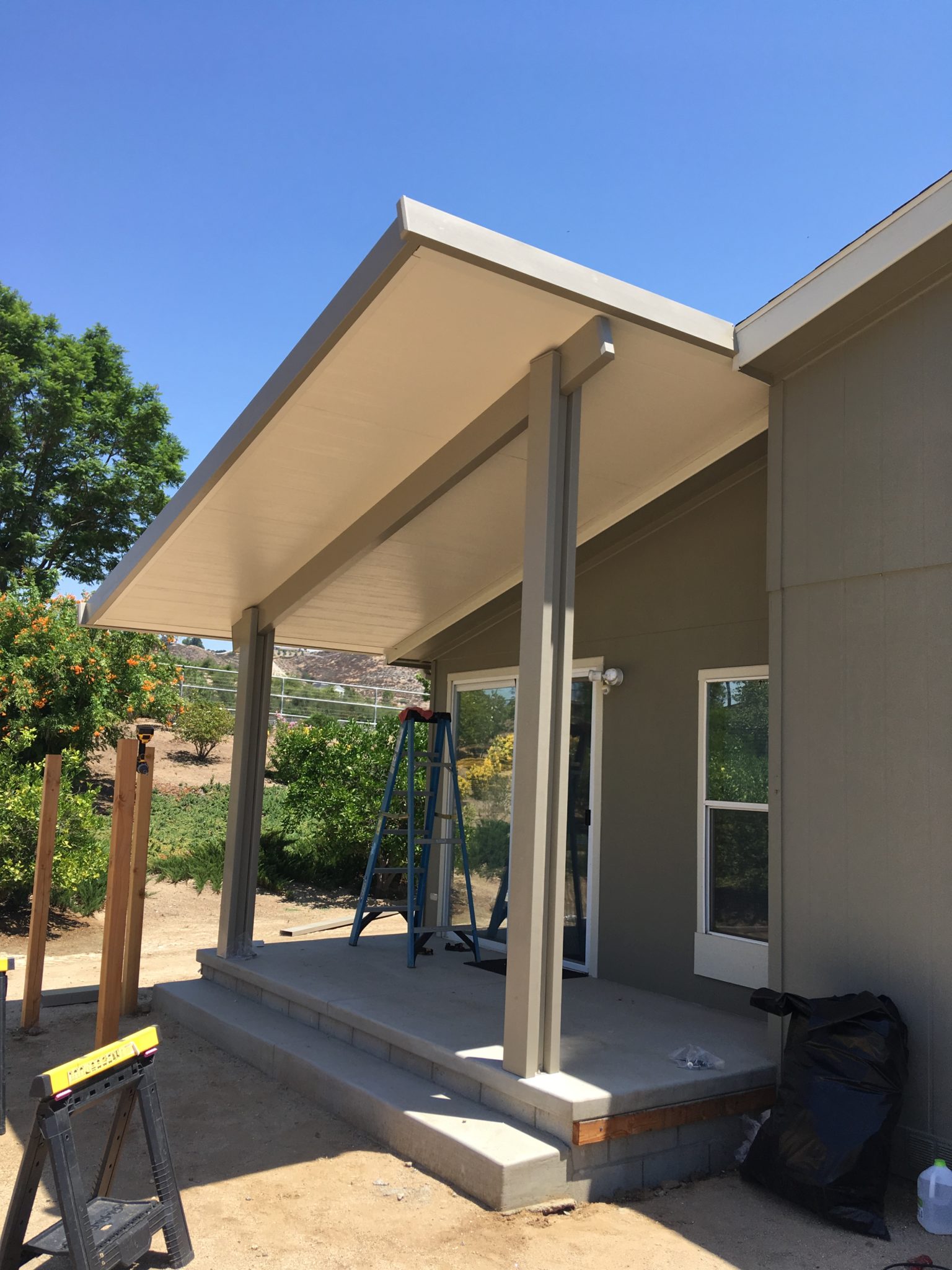 A TLA USA aluminum patio cover being installed on a Southern California home