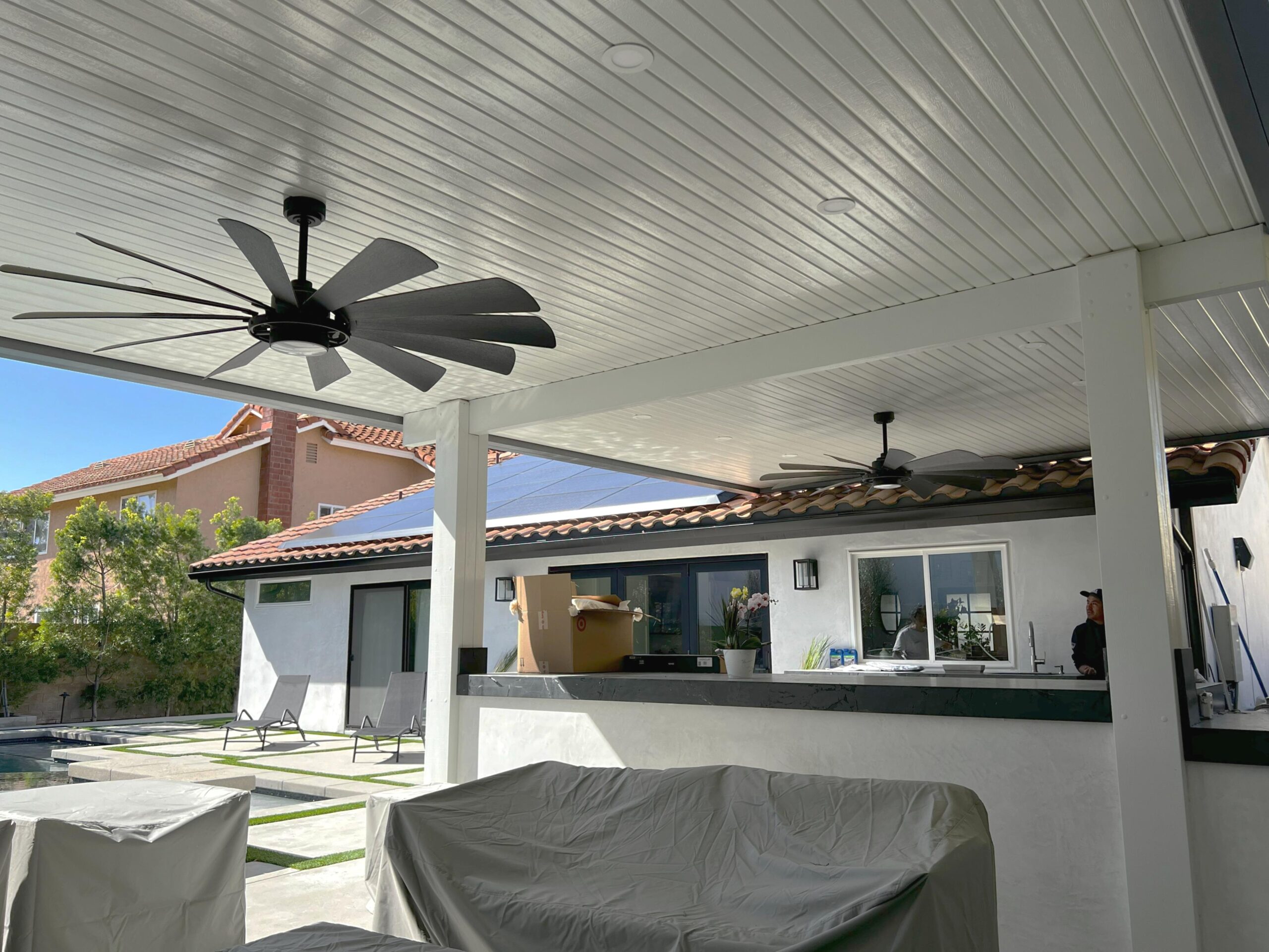 A Maxx Panel insulated aluminum patio cover over a modern poolside outdoor living area