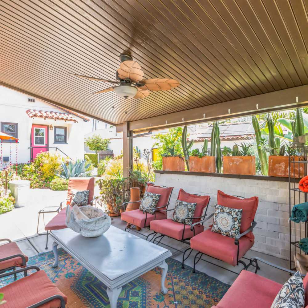 Wood-grain solid panel patio cover in lifestyle setting